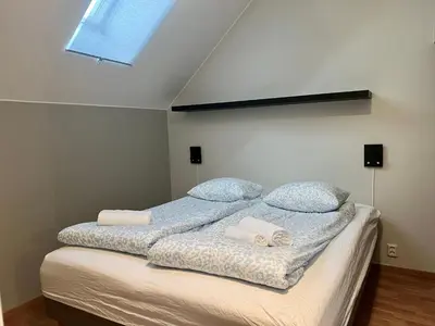 a bedroom with a bed with two pillows and a window at Vetrlidsallmenningen 4 in Bergen