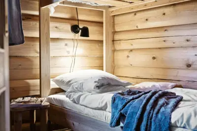 a bed in a room with a wooden wall at Cabin With Panoramic Views Over Trysil in Trysil