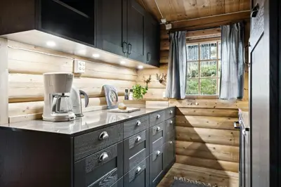a kitchen with wooden walls and a counter with a coffee maker at Cabin With Panoramic Views Over Trysil in Trysil