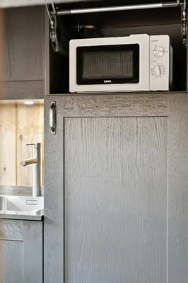 a microwave sitting on top of a cabinet in a kitchen at Cabin With Panoramic Views Over Trysil in Trysil