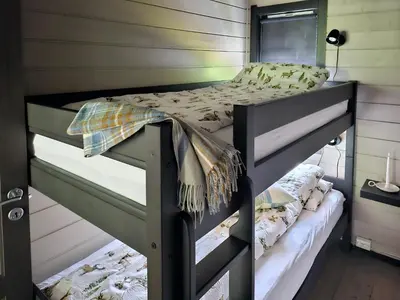 a bedroom with a bunk bed in a room at Mountain Cabin With Magical View And Tranquil Lake in Matre