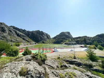 a park in the mountains with a skate park at Charming Seaside Cabin With Amazing View in Hardbakke