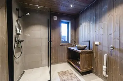a bathroom with a shower and a glass shower stall at Modern And Inviting Cabin In Valdres in Aurdal