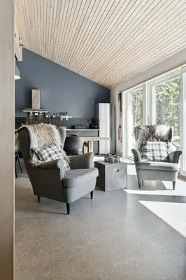 a living room with two chairs and a couch at Historic Cabin Idyll By Espedalsvannet in Espedalen