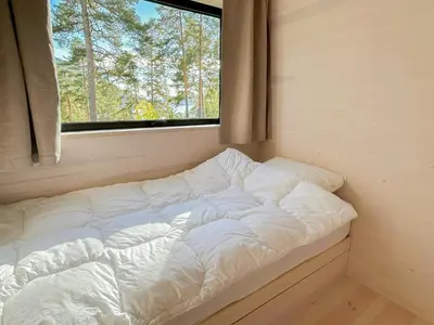 a large white bed in a room with a window at New Cabin By Tyrifjorden For Relaxing Holidays in Gjesval