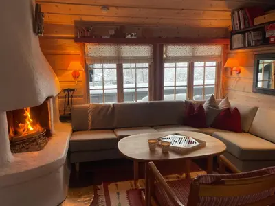 a living room with a couch and a fireplace at A Cozy, Rustic Retreat With Fireplace And Terrace in Beitostøl