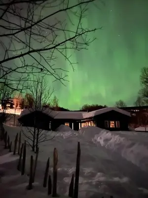an image of a house with the aurora in the sky at Charming and cozy cabin in Geilo in Geilo