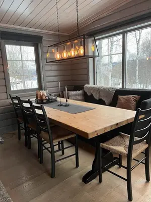 a dining room with a wooden table and chairs at Charming and cozy cabin in Geilo in Geilo