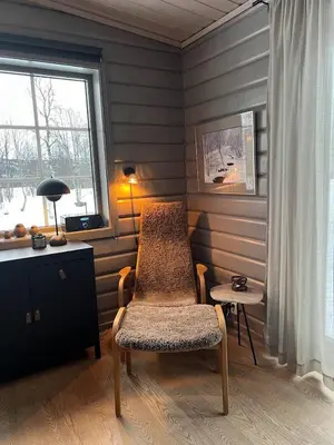 a room with a chair and a table and a window at Charming and cozy cabin in Geilo in Geilo