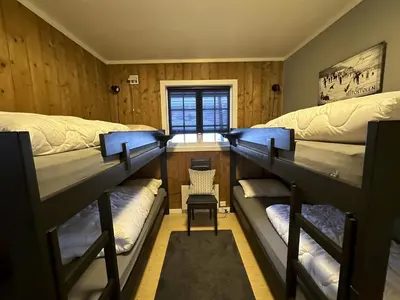 a room with three bunk beds and a chair at Modern 2-Bedroom Apartment In Ideal Location in Beitostøl