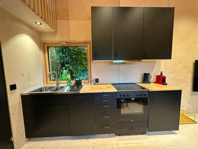 a kitchen with a sink and a stove at Mikrohus i byen - Tinyhouse Hamar city in Hamar