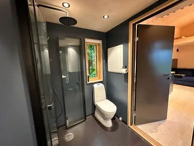 a bathroom with a toilet and a shower at Mikrohus i byen - Tinyhouse Hamar city in Hamar