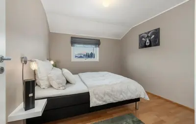 a bedroom with a bed with white sheets and pillows at SKI VM TRONDHEIM 2025- Private home in Tiller