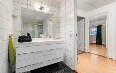 a white bathroom with a sink and a mirror at SKI VM TRONDHEIM 2025- Private home in Tiller