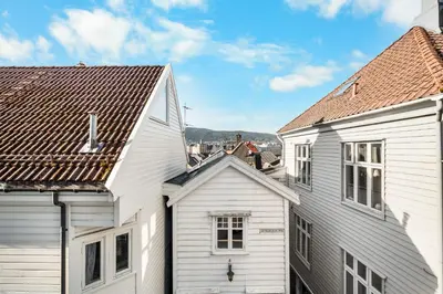 a view of the roofs of two white houses at Bryggen Historical Townhouse I Rooftop Views! in Bergen