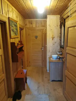 a hallway in a wooden cabin with a door at Brattland Sæter in Strond