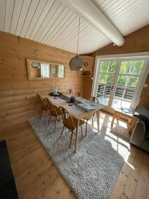 a dining room with a table and chairs at Koselig hytte på Beito in Beitostøl