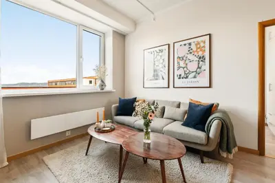 a living room with a couch and a table at 3-roms leilighet i hjertet av Sandviken in Bergen