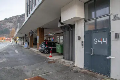 a car parked outside of a building with a garage at 3-roms leilighet i hjertet av Sandviken in Bergen