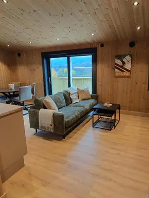 a living room with a couch and a table at Nye leiligheter på Blomberg i Hafjell in Hafjell