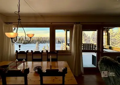 a dining room with a table and a large window at Apartment at Hafjell by Gaia ski-in out in Hafjell