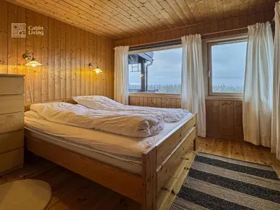 a bed in a wooden room with a window at Apartment at Hafjell by Gaia ski-in out in Hafjell