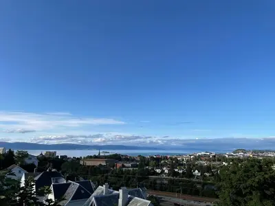 a view of the city and the water at Cozy apartment on the hill in Trondheim