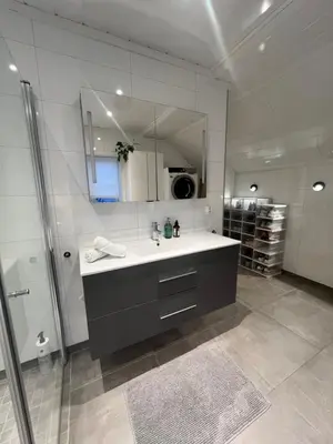 a bathroom with a sink and a mirror at Cozy apartment on the hill in Trondheim