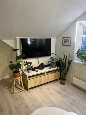 a living room with a large flat screen tv at Cozy apartment on the hill in Trondheim