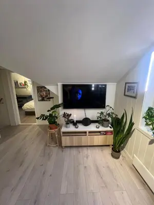 a large living room with a large flat screen tv at Cozy apartment on the hill in Trondheim