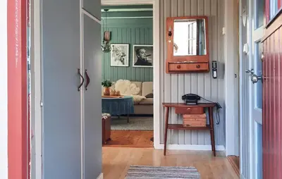 a hallway with a door leading to a living room at Stunning Home In Øydegard in Nastad