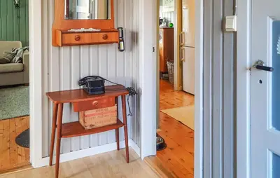 a small table in a room with a hallway at Stunning Home In Øydegard in Nastad