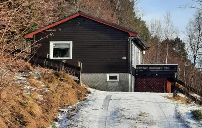 a black building with a window on the side of a road at Stunning Home In Øydegard in Nastad