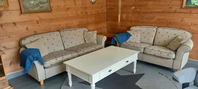 two couches and a coffee table in a room at Vassel gård in Herand