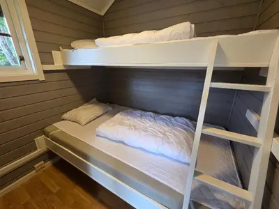 a room with two bunk beds in a cabin at Vassel gård in Herand