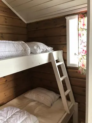 a bedroom with two bunk beds in a cabin at Vassel gård in Herand