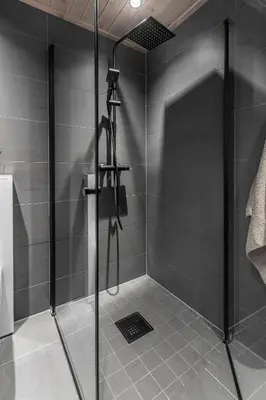 a shower with a glass door in a bathroom at New modern apartment with ski in out in Hafjell in Hafjell