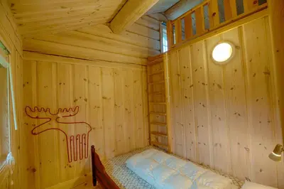 a wooden room with a bed in the corner at Peaceful Cabin Close To Beitostølen Center&Nature in Beitostøl
