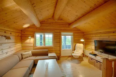 a living room with a couch and a tv at Peaceful Cabin Close To Beitostølen Center&Nature in Beitostøl