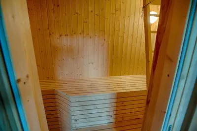 a wooden sauna with a wooden door leading into it at Peaceful Cabin Close To Beitostølen Center&Nature in Beitostøl