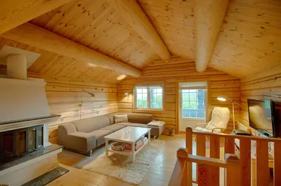 a living room with a couch and a fireplace at Peaceful Cabin Close To Beitostølen Center&Nature in Beitostøl