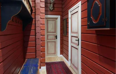 a red house with a door and a bench in a room at Amazing Home In Hovet With Sauna in Hovet