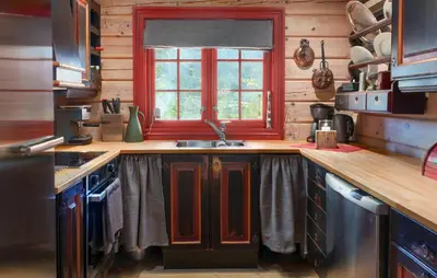 a kitchen with a sink and a red window at Amazing Home In Hovet With Sauna in Hovet