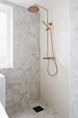 a shower with a glass door in a bathroom at New Apartment in Historical street in Bergen