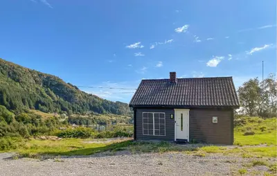 a small house sitting on top of a field at 1 Bedroom Beautiful Home In Korssund in Korssund