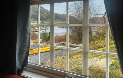 a window looking out at a view of a river at 1 Bedroom Beautiful Home In Korssund in Korssund