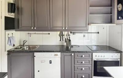 a kitchen with gray cabinets and a sink at 1 Bedroom Beautiful Home In Korssund in Korssund