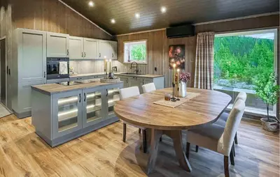 a kitchen with a wooden table and a wooden floor at 4 Bedroom Gorgeous Home In Koppang in Koppang