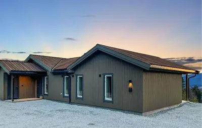 a house with a garage with a driveway at 4 Bedroom Gorgeous Home In Koppang in Koppang