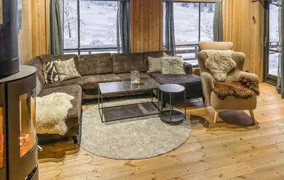 a living room with a couch and a table at Stunning Home In Flå With Sauna in Skadeland